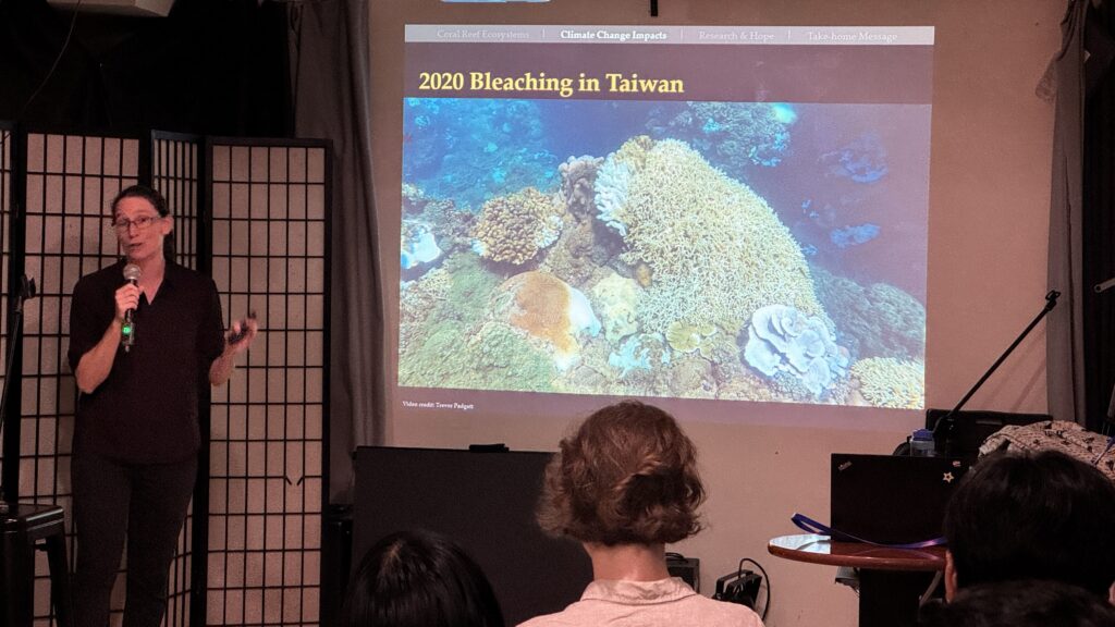 Photo of Professor McRae showing photo of coral bleaching in Taiwan