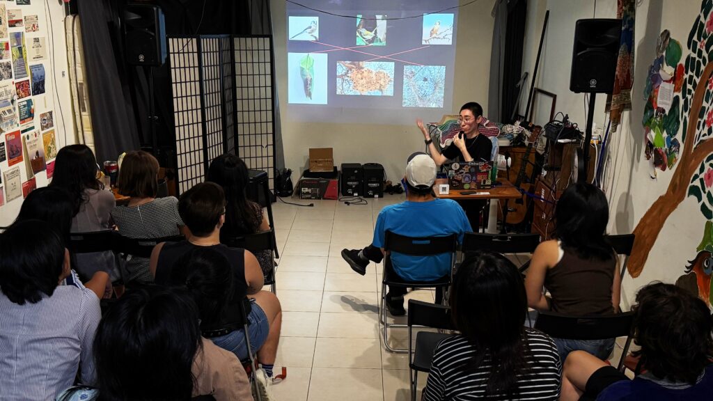 Photo of River Basham speaking in front of audience with slides of photos with lines matching other photos